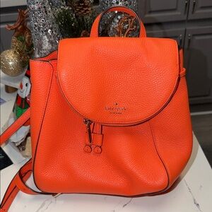 Kate Spade Leila Medium Flap Backpack in a vibrant orange, coral